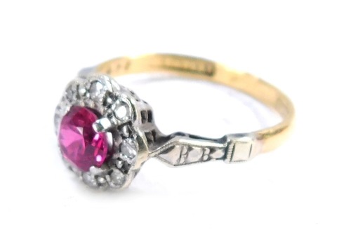 An 18ct gold and platinum cluster ring, with central garnet surrounded by tiny diamonds, white metal shoulders, size M, 2.5g all in.