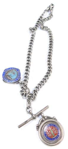 A silver curb link Albert watch chain and two fobs, one for the Derbyshire Times Walk May 1937 with enamel badge, and an Earl Shilton C of E School 1920 Cricket and Football shield, 51.5g all in.