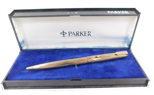 A 9ct gold Parker ballpoint pen, with engine turned decoration, 18g all in, boxed.
