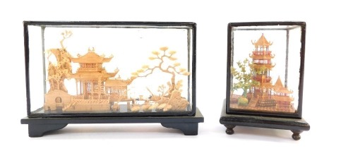 Two 19thC Chinese cork display cases, each of oval form with buildings and storks, 19cm and 14cm high. (2)