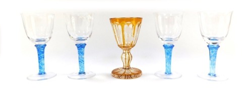 Five glasses, comprising a set of four blue twist stem wine glasses, and a Bohemian faceted amber flashed glad and floral engraved wine goblet. (5)