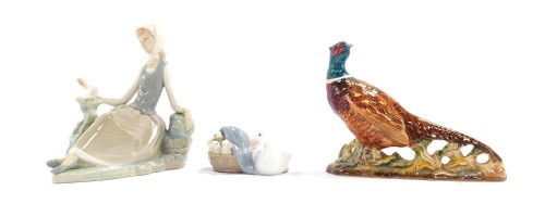 Two Lladro figures, comprising a lady reclining on rock with bird, 18cm high, goose and goslings, 6cm high, together with a Beswick pheasant, 15cm high. (3)