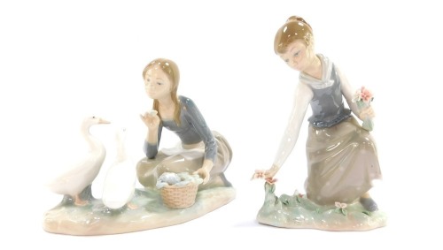 Two Lladro figure groups, comprising girl picking flowers, 22cm high, and a girl feeding cauliflower to geese, 17cm high. (2)