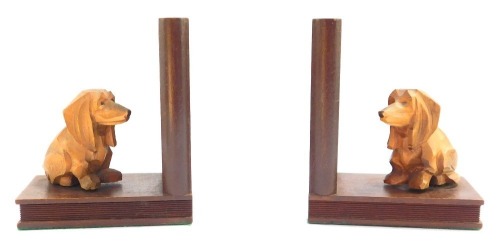 A pair of Art Deco turned wooden bookends, each decorated with a carved Corgi dog, 15cm high.