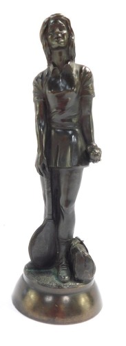 A bronze figure of a female tennis player, on a stepped base, 22cm high.