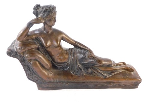 After Arnoux. A composite copy of a Parisian bronze, a lady reclining on a sofa, 32cm wide.