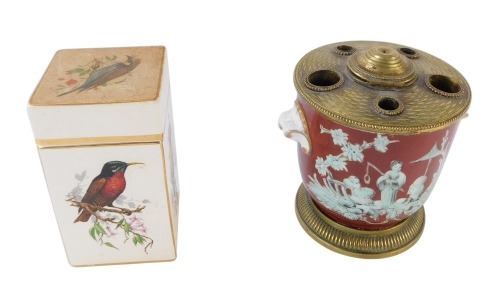 Two ceramics, comprising a Limoges pot pourri jar, with red ground and brass mounts, 10cm high, and a Carltonware painted bird jar and cover, square form, 12cm high. (2)