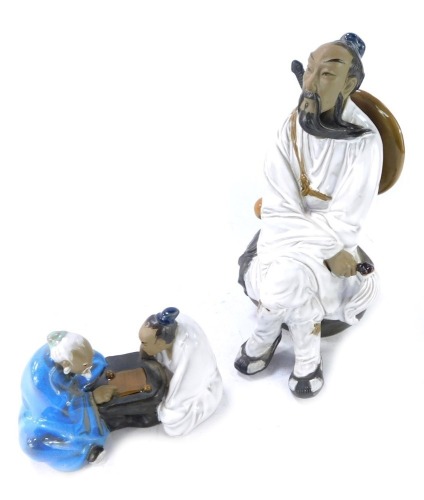 Two Chinese Mudmen figures, comprising a gentleman wearing cap, 26cm high, and two gentleman playing cribbage, 12cm high. (2)