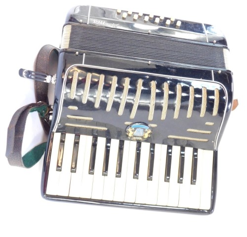 A Prima piano accordion, in travel case.
