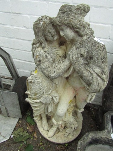 A reconstituted figure group, of a lady and gentleman in embrace, on circular base, 73cm high.