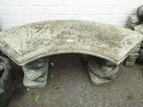 A reconstituted bench, with curved top on fish supports, 42cm high, 102cm wide, 36cm deep.