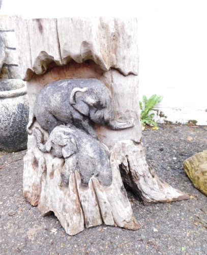 A carved wooden stump, depicting elephants, 40cm high.
