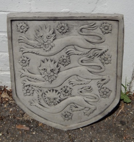 A reconstituted shield, three lions, 36cm high.