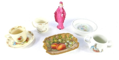 A group of ceramics, comprising a Royal Worcester fruits and flowers pin dish, Staffordshire figure of a lady, Bunnykins christening mug and cup and saucer, and a Peter Rabbit bowl and loving cup. (a quantity)