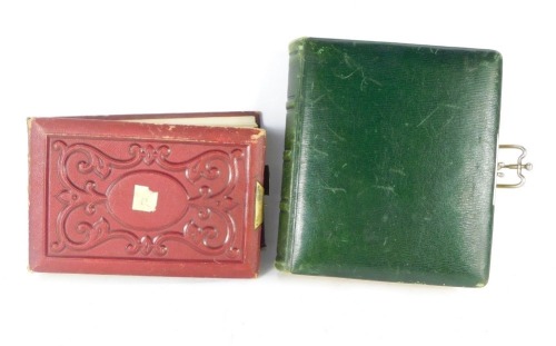 Two Victorian black and white photograph albums, comprising one green leather bound with half profile portraits, and another red book, with smaller 3/4 profile pictures. (2)