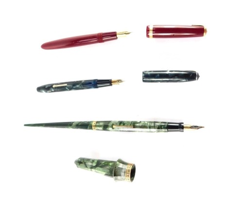 A Conway Stewart cracked iced fountain pen, with 14ct gold nib, together with a Parker Duofold fountain pen, with a 14ct gold nib, and an Eversharp mid century counter top green feathered fountain pen. (3)