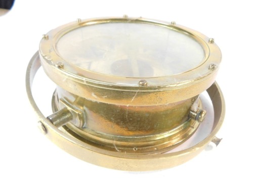 A Hau Johannesen of Grimsby brass cased gimbal compass, with a brass protected hood, 37cm diameter.