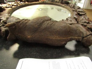 A 19thC wooden Black Forest oval wall mirror, the mirror plate in a carved frame of oak leaves, and four bears at intervals, 100cm high, 110cm wide. (AF) - 2