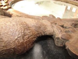 A 19thC wooden Black Forest oval wall mirror, the mirror plate in a carved frame of oak leaves, and four bears at intervals, 100cm high, 110cm wide. (AF) - 3