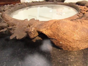 A 19thC wooden Black Forest oval wall mirror, the mirror plate in a carved frame of oak leaves, and four bears at intervals, 100cm high, 110cm wide. (AF) - 4