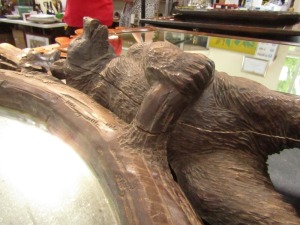 A 19thC wooden Black Forest oval wall mirror, the mirror plate in a carved frame of oak leaves, and four bears at intervals, 100cm high, 110cm wide. (AF) - 5