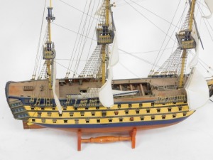 A wooden model of a galleon, over three tiers, with three masts, on turned base, 80cm high, 85cm wide, 23cm deep. - 2