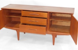 A teak sideboard, with arrangement of two doors and three drawers, on tapered legs, 73cm high, 151cm wide, 45cm deep. - 2
