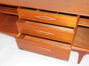 A teak sideboard, with arrangement of two doors and three drawers, on tapered legs, 73cm high, 151cm wide, 45cm deep. - 3