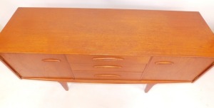 A teak sideboard, with arrangement of two doors and three drawers, on tapered legs, 73cm high, 151cm wide, 45cm deep. - 4