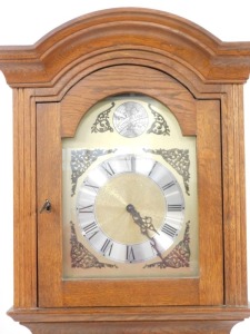 A 20thC oak cased longcase clock, with arched hood and brass dial with silvered chapter ring and spandrels, pendulum and weights, with single glazed door, 203cm high, 43cm wide, 25cm deep. - 2