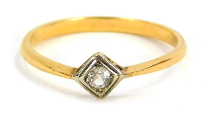 A diamond dress ring, the central diamond shaped rub over setting, with round brilliant cut diamond, in platinum, on a yellow metal plain band, unmarked, size R&frac12;, 2.5g all in.