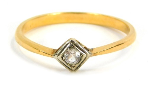 A diamond dress ring, the central diamond shaped rub over setting, with round brilliant cut diamond, in platinum, on a yellow metal plain band, unmarked, size R&frac12;, 2.5g all in.
