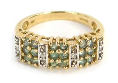 A peridot and CZ set dress ring, of three panelled design, yellow metal, stamped 9k, ring size N&frac12;, 3.8g all in.