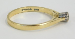 An 18ct gold diamond solitaire ring, with round brilliant cut diamond in claw setting, approx 0.10cts, on a pierced shank, ring size P&frac12;, 2.8g all in. - 2