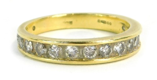 An 18ct gold diamond half hoop eternity ring, set with fourteen round brilliant cut diamonds in tension setting, each approx 0.03cts, ring size P, 4g all in.