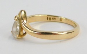 A diamond eternity ring, with tear drop cut diamond in V tension link setting, the diamond approx 0.25cts, on a yellow metal band, stamped 18ct, ring size L, 2.9g all in. - 2