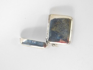 A George V silver vesta case, Birmingham 1943, bearing the initials JAC, a silver butter knife, a pair of Victorian silver shell capped sugar tongs, and a silver pickle fork with twist stem and bobble end, 2&frac14;oz. (4) - 2