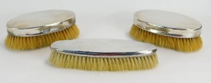 A George V silver dressing table set, bearing the initial J, Birmingham 1918, comprising two short and one long brush in a Baker's Dual Casket Market Place, Wigan presentation box. - 3