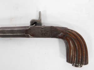 An early 19thC box lock percussion pocket pistol with detachable part turned and octagonal twist barrel, engraved lock, concealed trigger and carved walnut handle, 23cm. - 4