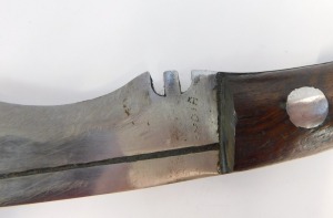 A curved Kukri dagger, marked TD with military arrows and two miniature blades, in a leather scabbard, 45cm wide. - 3