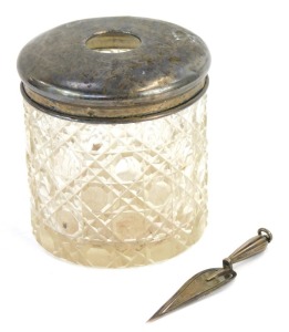 A silver topped dressing table jar and a miniature silver trowel, weighable silver &frac34;oz.