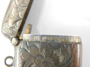 A George V silver cigarette case, with engraved borders and monograms, Birmingham 1917, another similar and a vesta case. (3) - 5