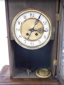 An early 20thC walnut mantel clock, with Vienna style fret moulded horse top, brass and ceramic numeric dial, 72cm high, 31cm wide, 15cm deep. - 2