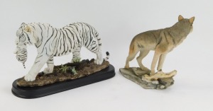 A Country Artist figure of a white tiger, on a black base, 22cm high, 36cm wide, boxed, and a further model of wolf, 22cm high. (2) - 2