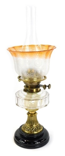 A 19thC brass oil lamp, with an orange and butterfly floral shade, marked Spink and Sons, 38cm high.