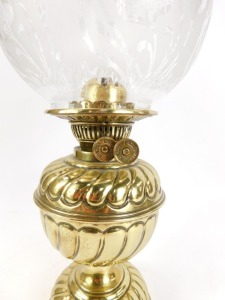 A 19thC brass oil lamp, with domed floral glass shade, on a fluted stem, 40cm high. - 2