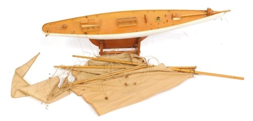 A wooden pond yacht, with three masts, 89cm wide.