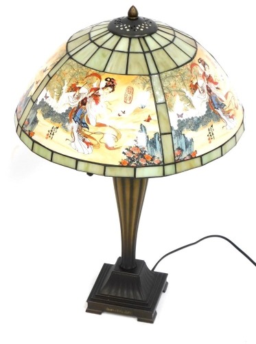 A Eastern inspired table lamp, on square set foot with a green oriental shade, 75cm high.