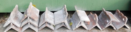 Fifteen terracotta ridge tiles, each with a ribbed top. (AF)