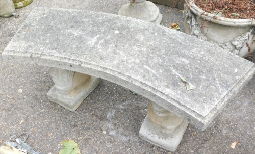 A reconstituted stone garden bench, the curved top on squirrel supports, 44cm high, 94cm wide, 37cm deep.